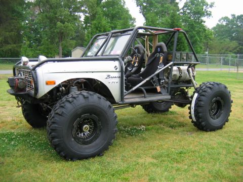 1992 Ford Mustang - This heavily modified off-road vehicle features a roll cage and oversized tires, with a "Bronco" badge indicating its heritage.