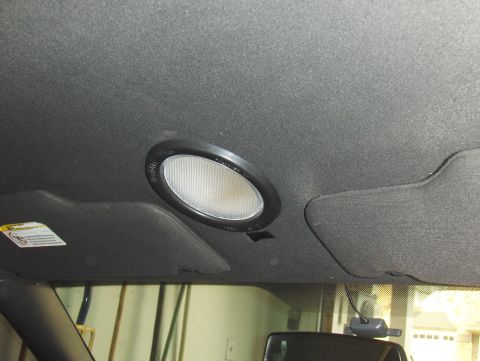 2003 Ford Crown Victoria - The interior dome light and visor are visible in this close-up shot.