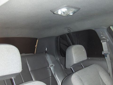 2003 Ford Crown Victoria - Interior view of the rear seating area, showing headrests, seatbelts, and the car's ceiling.