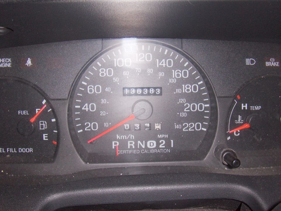 Speedometer reads 136,383 miles, fuel gauge near E, temp gauge in C range
