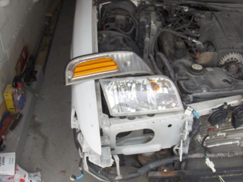 2003 Ford Crown Victoria - The front end of a 2003 Ford Crown Victoria is shown with the bumper removed and the engine exposed.