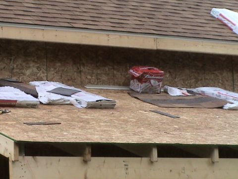 1946 Ford F1 - Bundles of shingles and a Budweiser box sit on the plywood sheeting of a roof under construction.