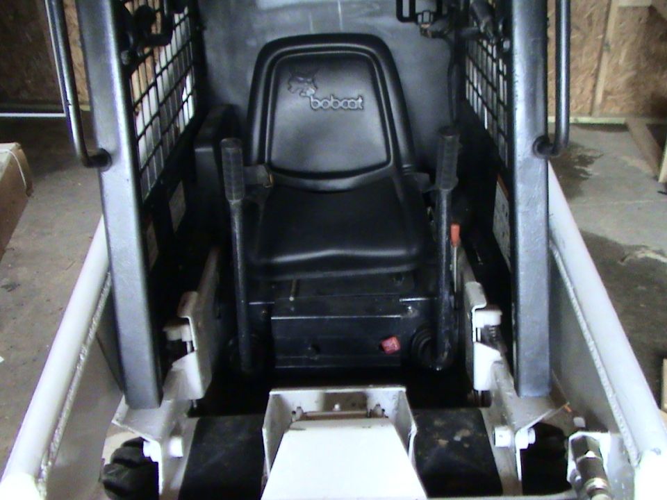 Bobcat skid steer loader interior with black seat and controls