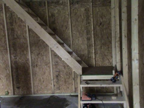 1946 Ford F1 - Construction in progress with wooden stairs and shelves against OSB walls.