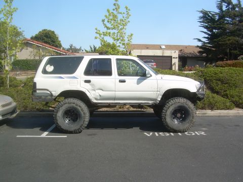 1993 Toyota 4Runner - This modified 1993 Toyota 4Runner features a lifted suspension and large off-road tires, indicating it is built for terrain.