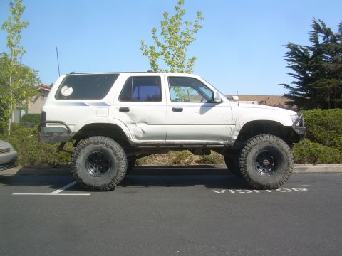 1993 Toyota 4Runner - This modified 1993 Toyota 4Runner features a lifted suspension and aggressive off-road tires, indicating it's built for challenging terrain.
