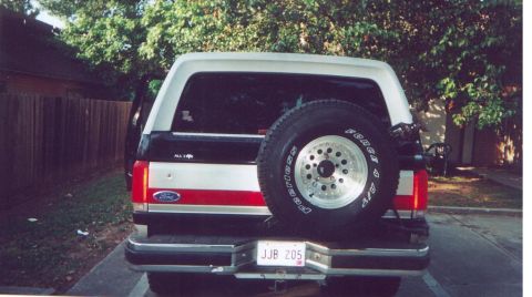 1990 Ford Bronco - Rear view of a 1990 Ford Bronco, a spare tire and a two-tone paint scheme.