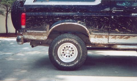 1990 Ford Bronco - This SUV is covered in mud, showing its BFGoodrich All-Terrain tires and a spare tire mounted on the rear.