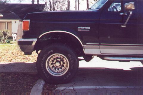 1990 Ford Bronco - The side profile of a Ford Bronco shows its "Bronco" badging and two-tone paint scheme.