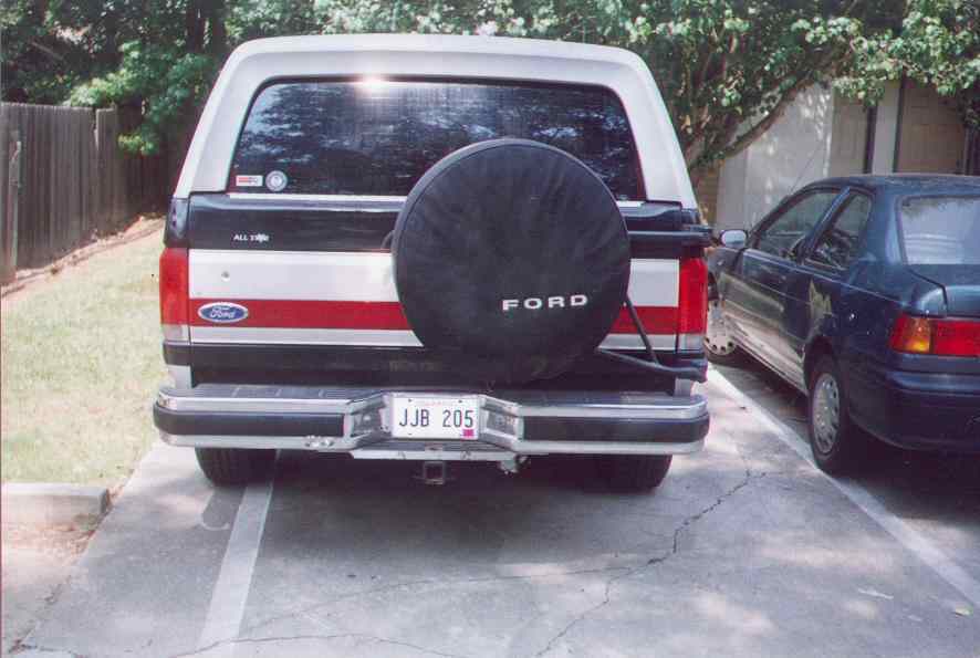 Rear view of 1990 Ford Bronco with spare tire and red stripe