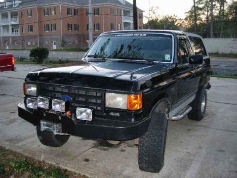 1990 Ford Bronco - Black 1990 Ford Bronco with custom front bumper and auxiliary lights.