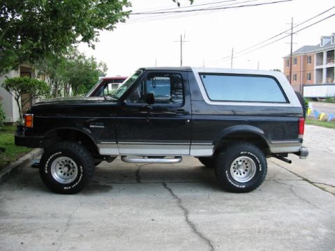 1990 Ford Bronco - This 1990 Ford Bronco is shown from the side, its distinctive two-tone paint scheme and off-road tires.