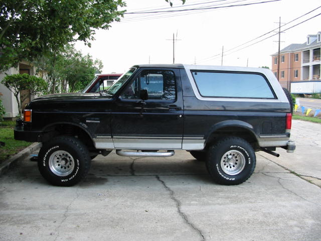 Side view of a black and silver 1990 Ford Bronco with BFGoodrich All-Terrain T/A tires