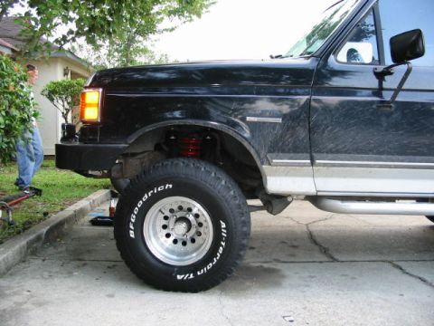 1990 Ford Bronco - Side view of a 1990 Ford Bronco showing the front fender, wheel, and tire.