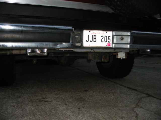 Rear bumper with license plate JJB 205, trailer hitch, and tire visible