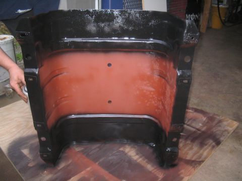 1979 Ford Bronco - A black and orange metal part is shown from the interior, possibly a component for a vehicle swap.