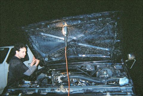 1988 Ford Bronco - Shane working on tuning the beast. Notice the dirty INSIDE of my hood, I was playing in some puddles (more like lakes) before the engine we…