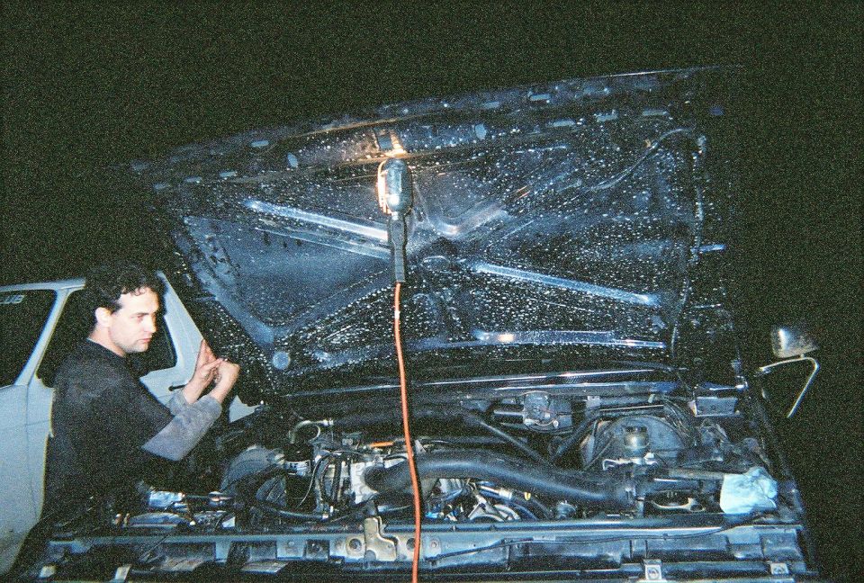 Shane working on tuning the beast.  Notice the dirty INSIDE of my hood, I was playing in some puddles (more like lakes) before the engine went, wonder if that had something to do with it.