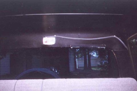 1990 Ford Bronco - Interior view showing an overhead light fixture and the rear window.