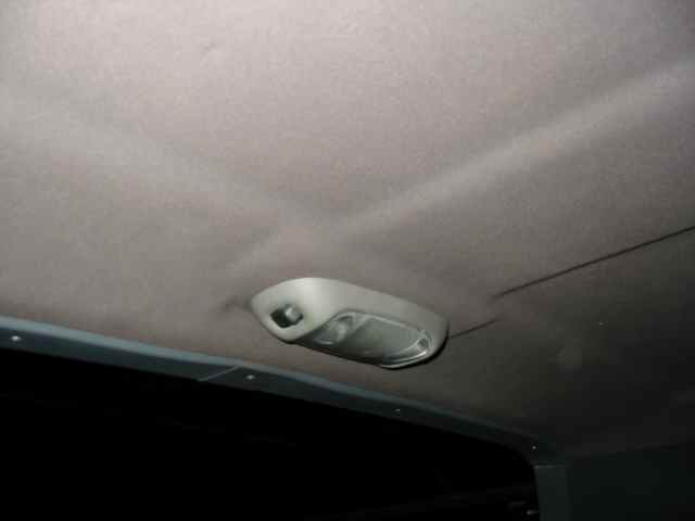 Interior overhead light fixture on a vehicle headliner