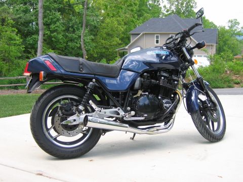1985 Ford LTD Crown Victoria - Photograph of a blue Suzuki motorcycle outdoors, not a technical document.