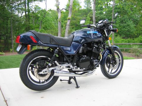 1985 Ford LTD Crown Victoria - Photograph of a blue Suzuki motorcycle from the rear, not a technical document.