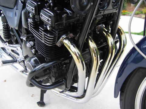 1985 Ford LTD Crown Victoria - Photograph of a motorcycle engine and chrome exhaust headers, not a technical document.