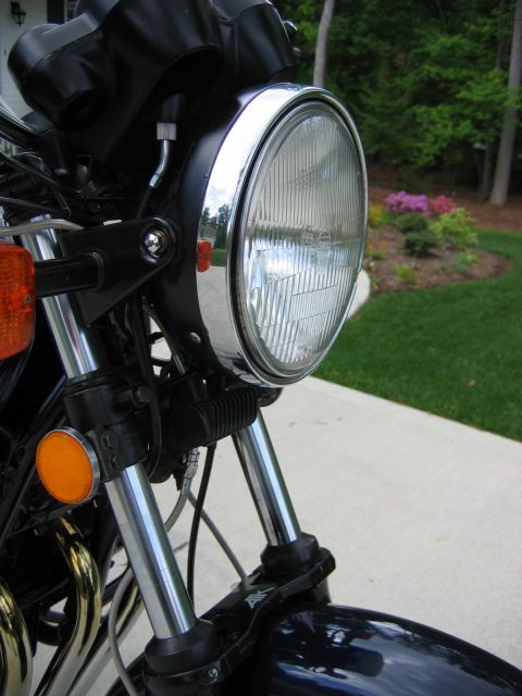 1985 Ford LTD Crown Victoria - Photograph of a motorcycle headlight and front fork, not a technical document.