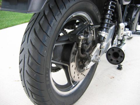 1985 Ford LTD Crown Victoria - Photograph of a motorcycle rear wheel and brake, not a technical document.