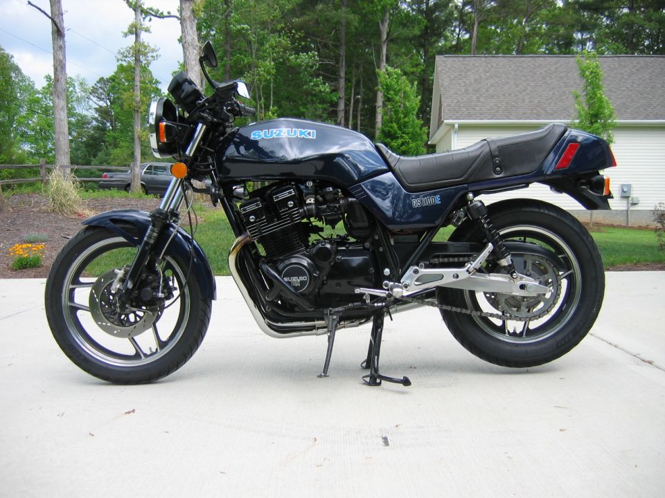 Dark blue Suzuki GS1100E motorcycle parked on a concrete driveway, side view