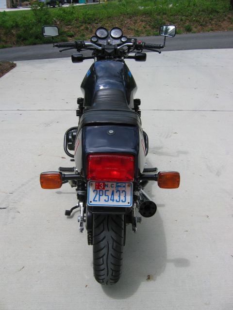 1985 Ford LTD Crown Victoria - This motorcycle is viewed from the rear, showing its taillight and license plate.