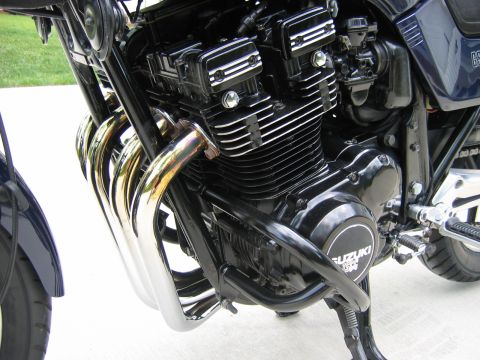 1985 Ford LTD Crown Victoria - Close-up of a Suzuki GS motorcycle engine, showing the exhaust headers and engine block.