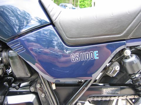 1985 Ford LTD Crown Victoria - Side view of a blue motorcycle with "GS1100E" badging.