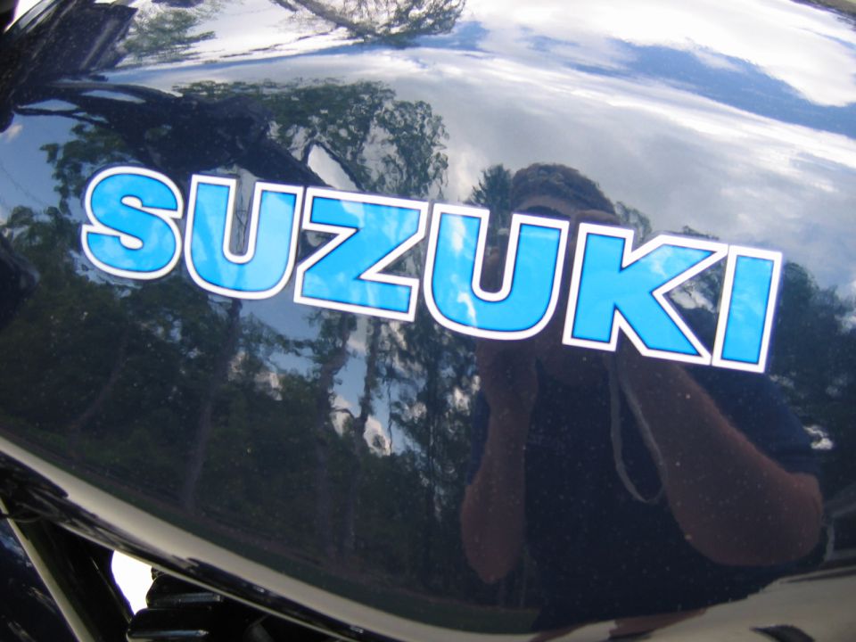 Dark blue motorcycle tank with blue SUZUKI lettering