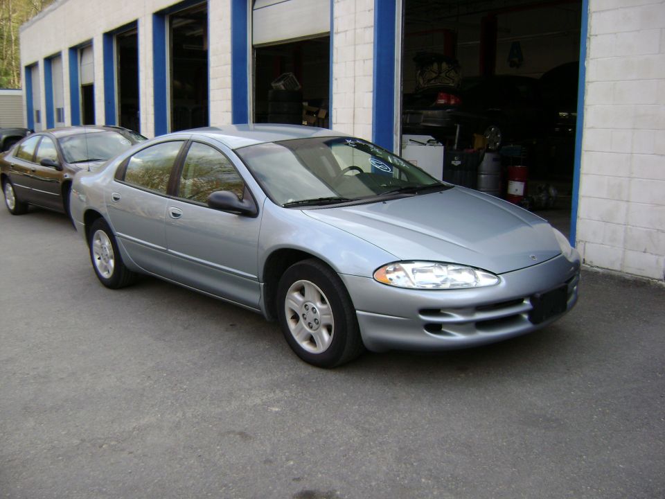Silver sedan parked outside a garage