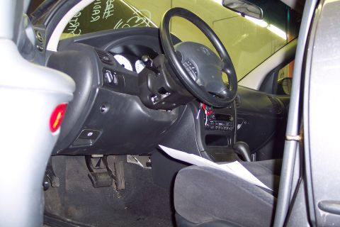 2001 Ford Crown Victoria - Interior view of a car, focusing on the dashboard, steering wheel, and driver's seat.
