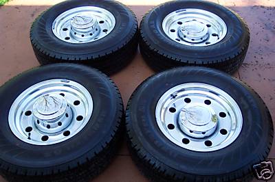2006 Ford E250 - A set of four tires and rims are displayed, likely for sale or replacement.