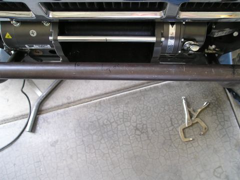 1986 Toyota Hilux - Close-up of a vehicle's front bumper with a winch installed, and locking pliers nearby.
