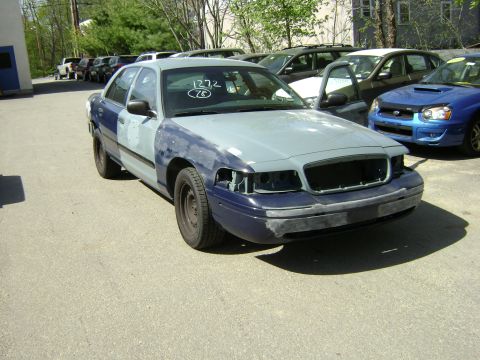 2001 Ford Crown Victoria - This 2001 Ford Crown Victoria is in the process of body repair, with primer visible on the hood and fenders.
