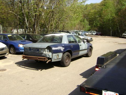 2001 Ford Crown Victoria - This 2001 Ford Crown Victoria is in a state of repair, with mismatched body panels and a missing bumper.