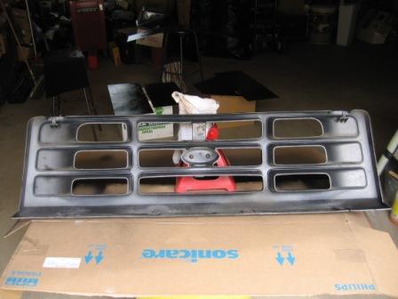 1993 Ford Bronco - Grille for a 1993 Ford Bronco, shown indoors on a cardboard box.
