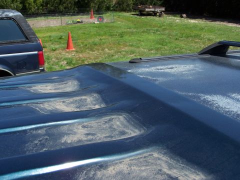 1995 Ford C-150 (Centurion Conversions) - Close-up of a weathered SUV roof, with another vehicle visible in the background.