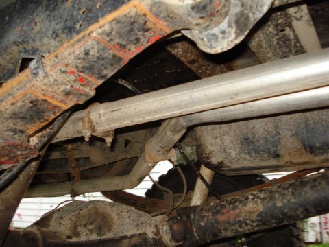 1981 Ford F-250 - The underside of a 1981 Ford F-250 reveals significant rust on the frame and suspension components.