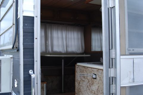 1987 Ford F-250 - Camper interior with curtains drawn over windows and a small countertop area visible.