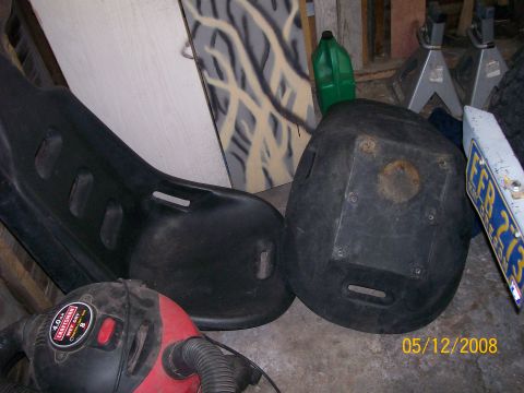 1984 Ford Bronco - Two black plastic seats and a shop vac are visible in this garage scene.