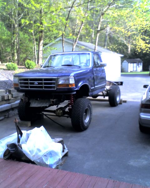 1996 Ford F-150 - Blue 1996 Ford F-150 chassis on display, showing its lifted suspension and bare frame.