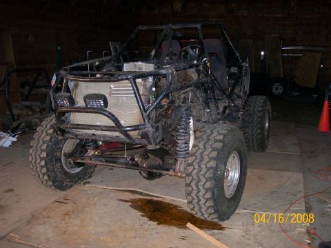 1984 Ford Bronco - This custom off-road vehicle appears to be undergoing modifications or repairs in a workshop setting.