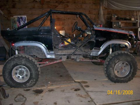 1984 Ford Bronco - This heavily modified vehicle, likely a Ford Bronco from the early 1980s, has been stripped down and fitted with a roll cage and oversized…