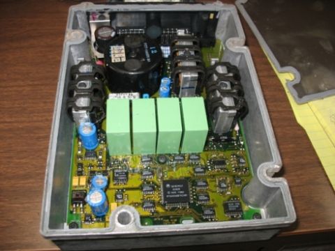 1995 Ford C-350 (Centurion Conversions) - Close-up of an electronic control unit's internal components, including a circuit board with various chips and capacitors.