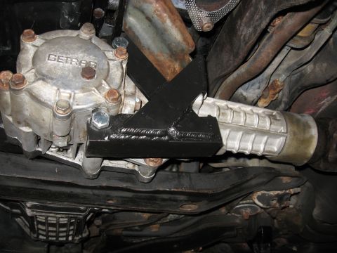1991 Mitsubishi 3000GT - Close-up view of the underside of a vehicle, focusing on transmission and differential parts.